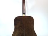 a close up of a guitar on a stand against a white background