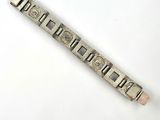 a silver bracelet that is on a white surface