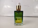 a close up of a bottle of oil sitting on a table