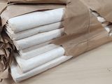 several rolls of toilet paper are wrapped in brown paper on a table