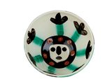 a white bowl with a black and green design on it