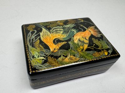 a black box with a painting of two birds on it