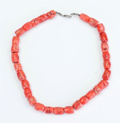 a red coral beaded necklace on a silver chain