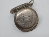 an antique silver pocket watch on a white surface