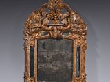 an ornately carved mirror in the shape of a frame with flowers and leaves on it