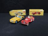 three toy cars are sitting next to each other on a black surface