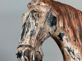 a statue of a horse that is painted brown and black