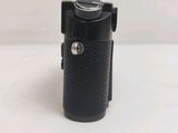 a black camera that is sitting on a white table