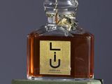 a bottle of perfume sitting on top of a green box