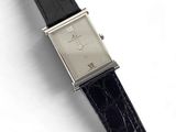 an image of a watch with a black strap on a white surface
