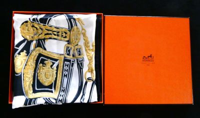 an orange box with a gold chain and a scarf in it