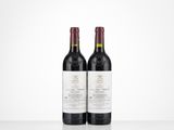 two bottles of wine sitting on top of a white table