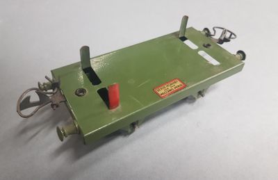 a green machine that is sitting on a white surface