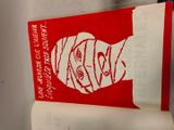 a red and white book with a picture of a man ' s face on it