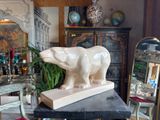 a statue of a bear on a table in a living room
