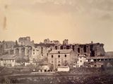 an old photo of a city with a castle in the background