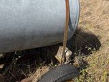 a large metal tank sitting in the middle of a field