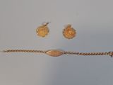 two pieces of jewelry are shown on a white surface