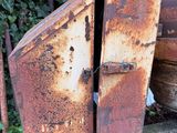 an old rusted metal container sitting on top of a wooden cart