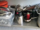 many pots and pans on the counter in the kitchen