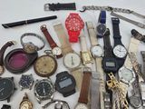 many different types of watches on a white table