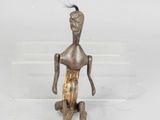 a small bronze figurine of a man with a bird on his head