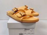 a pair of sandals that are on top of a box