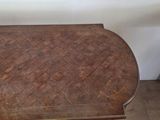 a small table with a wooden top on a hard wood floor