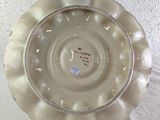a white plate with a design on it sitting on a table