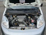 a car with its hood open and the engine in the back