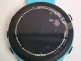 someone is looking at a smart watch on a white surface