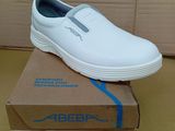 men ' s white slip on shoes in a box on a table