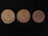three different types of coins are shown on a black surface