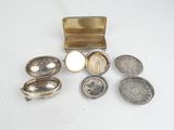 several silver objects are sitting on a white surface