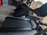 two tread machines that are on the floor in the room