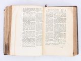an open book on a white table with a white background