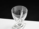 a clear glass cup sitting on top of a white table