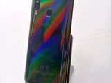 the back of a black phone with a multicolored design on it