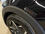 a close up of a black car with a sticker on it