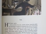 an open book with a picture of a man sitting at a table