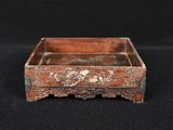 an old wooden box with a floral design on it