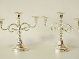 pair of silver plated candelabs with ornate designs