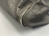 the inside of a silver purse with a zipper on it
