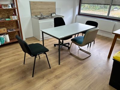 a table and chairs in a room with a large window