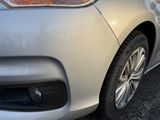 a close up of a car ' s front bumper with a cat on it