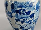 a blue and white vase sitting on a table