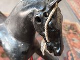 a statue of a horse with a rope on its head