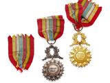 two medals and a medal are sitting on a white surface