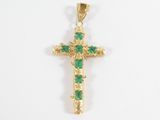 an image of a gold cross with green stones on a white background
