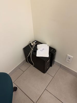 an image of a small room with a desk and a chair